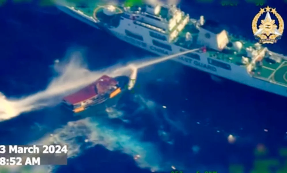 In this screen grab from video provided by the Armed Forces of the Philippines, a Chinese coast guard ship uses water cannons on a Philippine resupply vessel Unaizah May 4 as it approaches Second Thomas Shoal, locally called Ayungin shoal, at the disputed South China Sea on Saturday, March 23, 2024. (Armed Forces of the Philippines via AP)