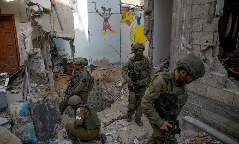 Israeli soldiers stand at the entrance of a tunnel where the military says six Israeli hostages were recently killed by Hamas militants, in the southern Gaza Strip on Friday, Sept. 13, 2024. (AP Photo/Leo Correa)