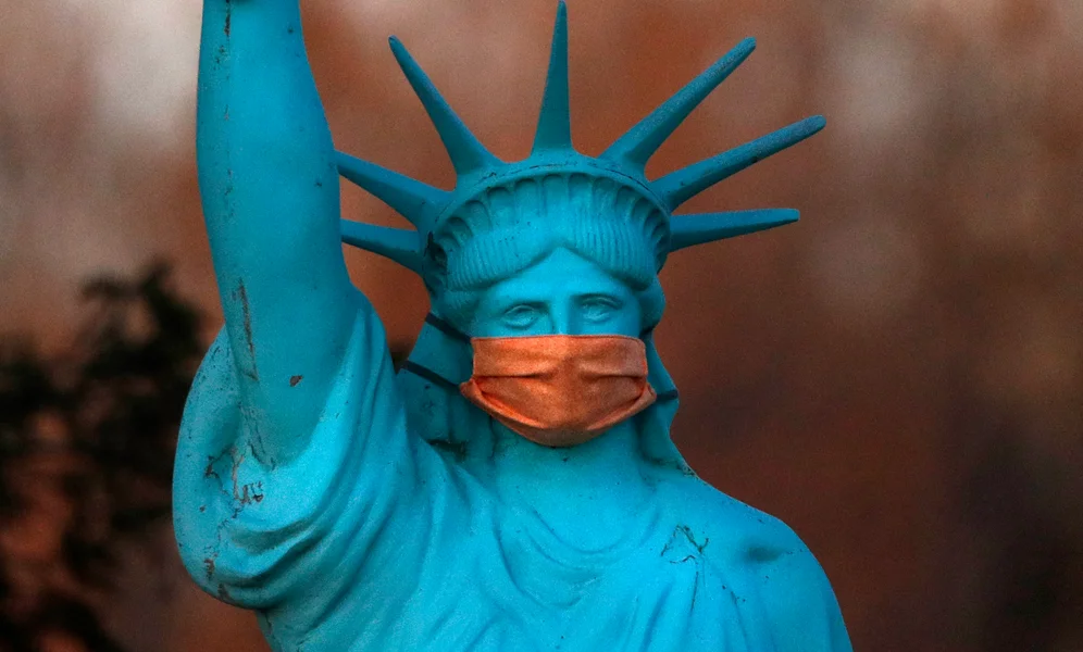 A replica of the Statue of Liberty wears a coronavirus mask outside a home on Deer Isle, Maine, Wednesday, May 6, 2020. (AP Photo/Robert F. Bukaty)